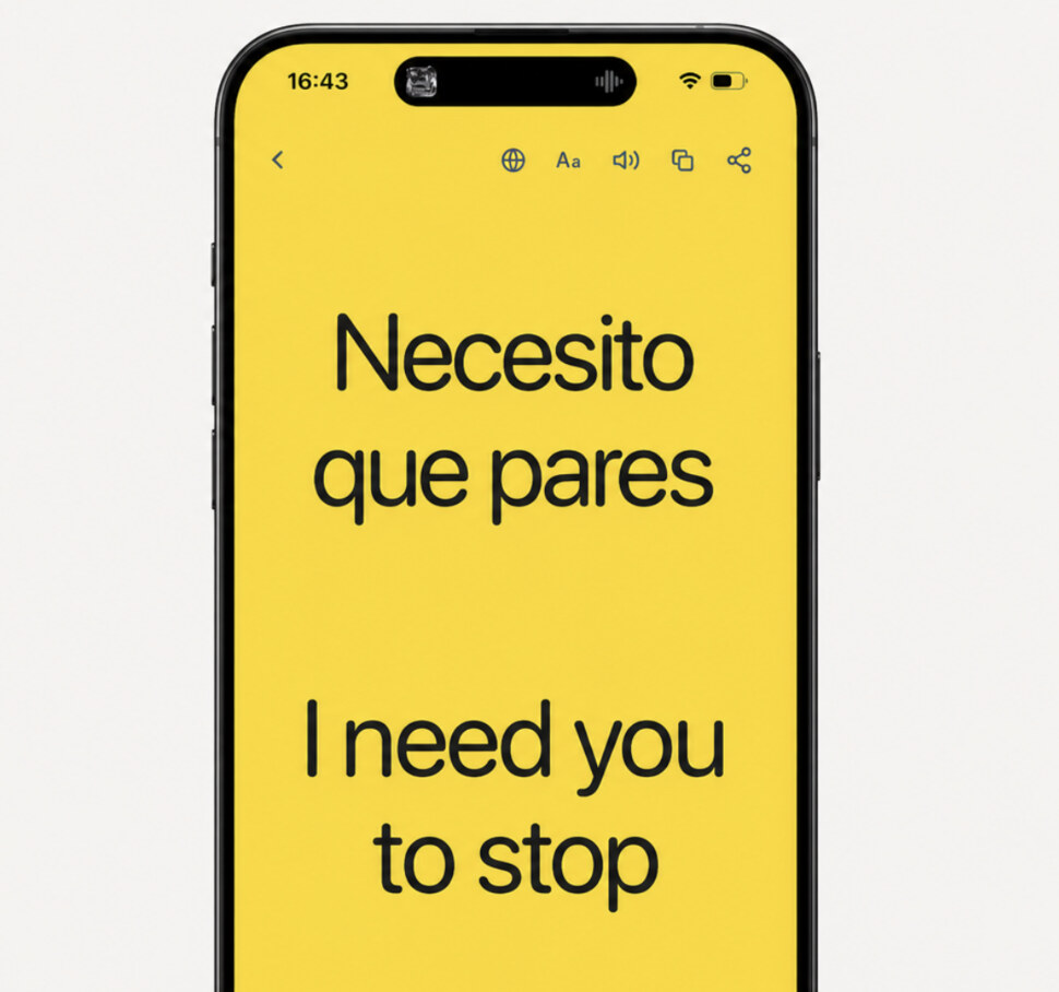The Showju app on a phone, showing a full-screen yellow message: 'Necesito que pares' above its English translation, 'I need you to stop'.